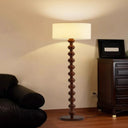 Unique Modern Gourd Floor Lamp - Mid-Century Elegance LB-QDH-LD-2009 $299.00 Discover the unique modern floor lamp crafted from walnut wood and fabric. Elevate your space with this mid-century, elegant, and cozy lighting solution.